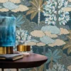 blue botanical wallpaper and wall with side table and vases
