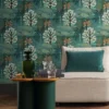 blue botanical wallpaper and wall with armchair and cushion