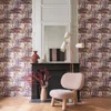 purple botanical wallpaper and wall with armchair and vases