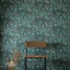 blue botanical wallpaper and wall with chair and plants