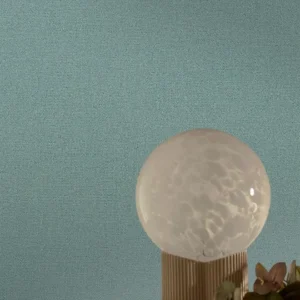 blue plain wallpaper and wall with side table and lamps