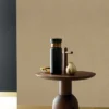 yellow plain wallpaper and wall with coffee table and vases