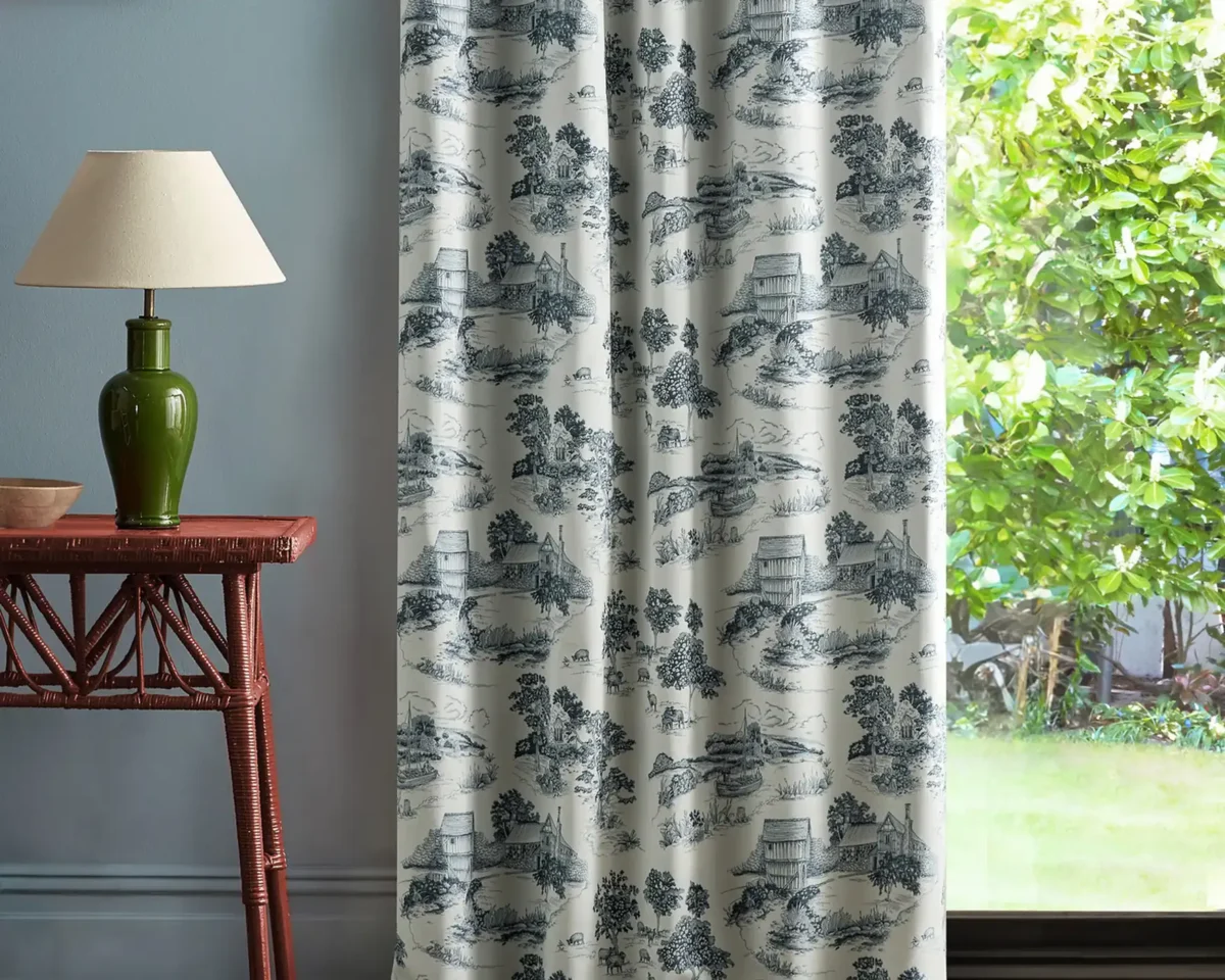 Brockhampton Estate Fabric - Woad by black-grey botanical curtain with side table and lamps