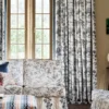 purple striped curtain with cushion and vases