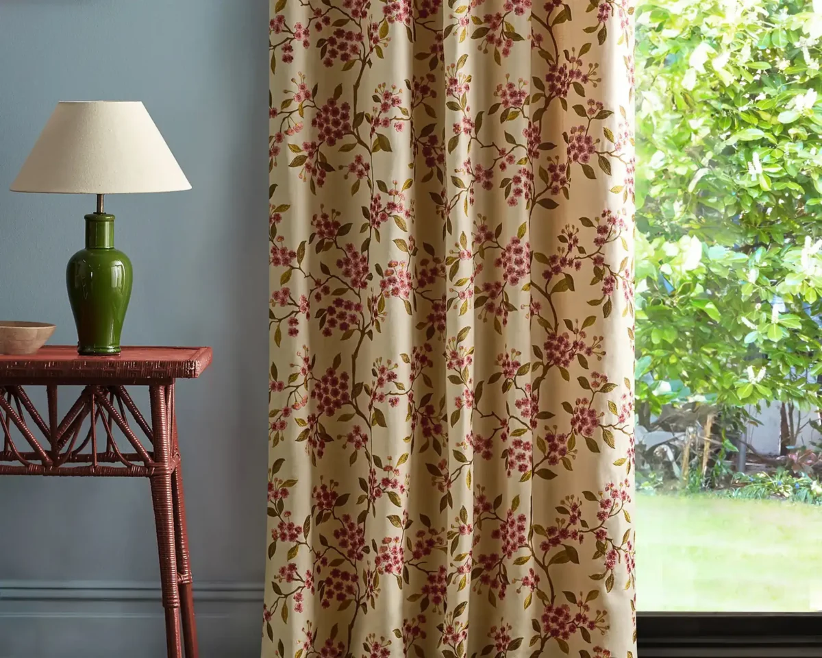 red botanical curtain with side table and lamps