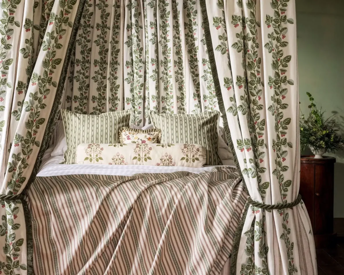 Goldings Hops Fabric - Lichen / White Blossom by brown botanical bed with cushion and curtain
