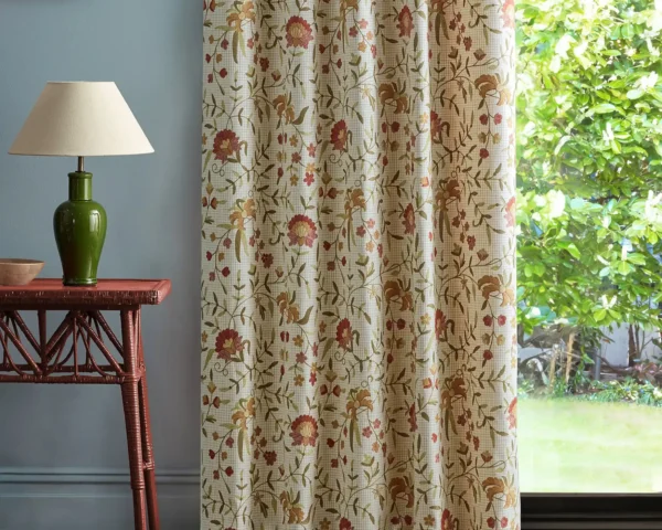 red botanical curtain with side table and lamps