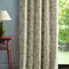blue botanical curtain with side table and lamps