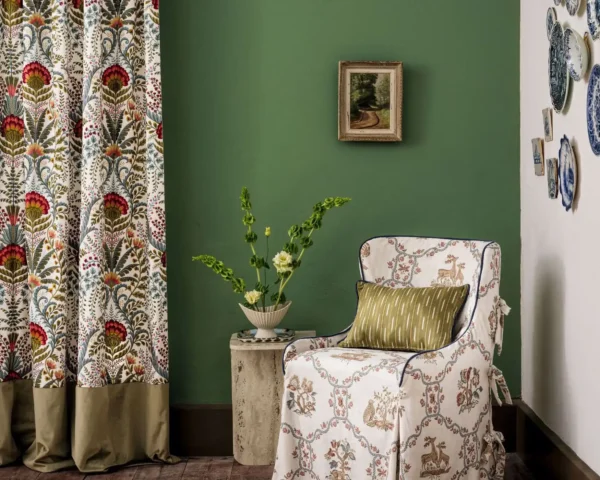 Marrienne Fabric - Chintz by red botanical curtain with armchair and vases