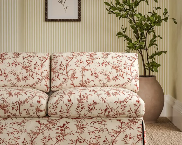 Paradise Woods Toile Fabric - Madder by red botanical sofa with plants