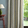 blue striped curtain with side table and lamps