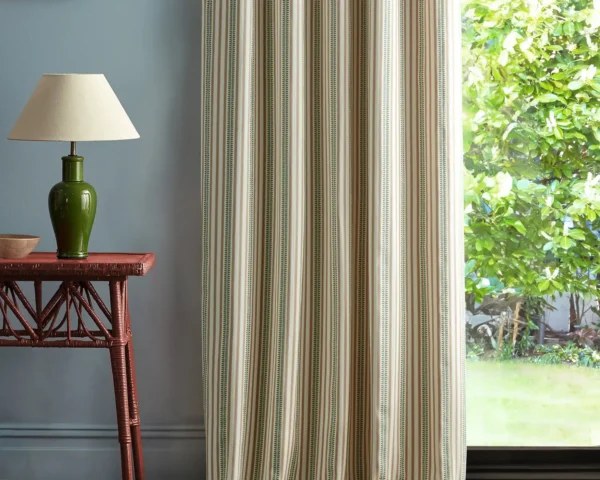 orange striped curtain with side table and lamps
