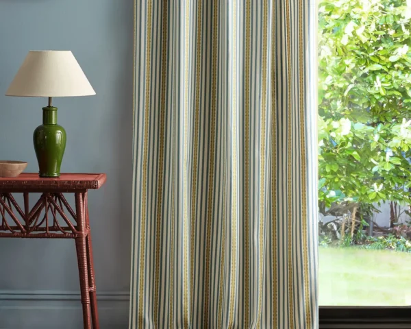 Barneby Stripe Fabric - Woad / Olive by blue striped curtain with side table and lamps