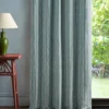 blue striped curtain with side table and lamps