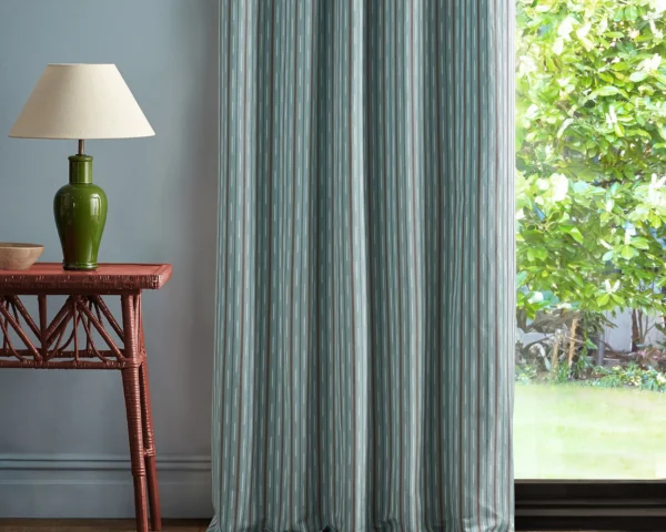 blue striped curtain with side table and lamps