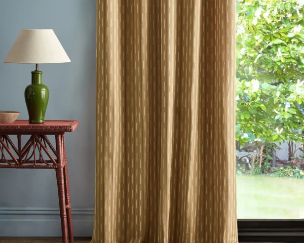 Sabu Stripe Fabric - Golden Knot by yellow striped curtain with side table and lamps
