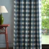 blue checked curtain with side table and lamps
