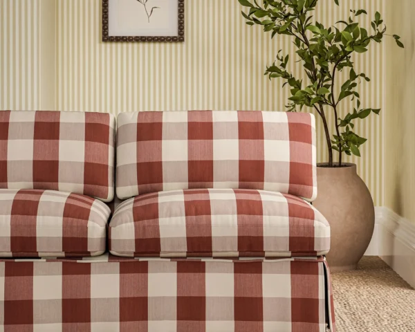 Madras Fabric - Check Madder by red checked sofa with plants and wall