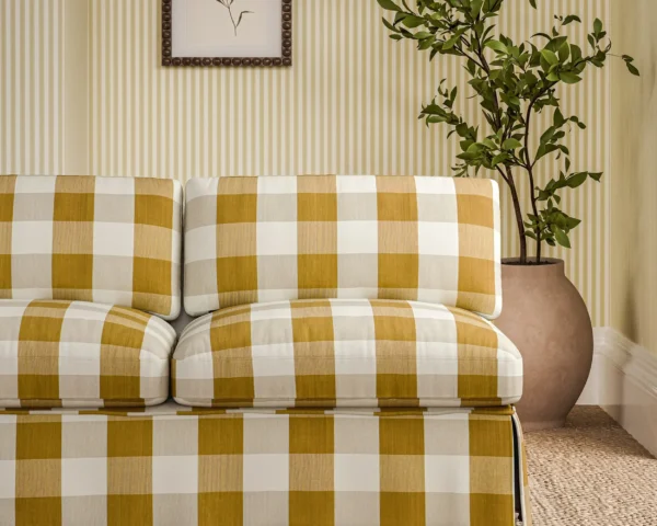 yellow checked sofa with plants and wall