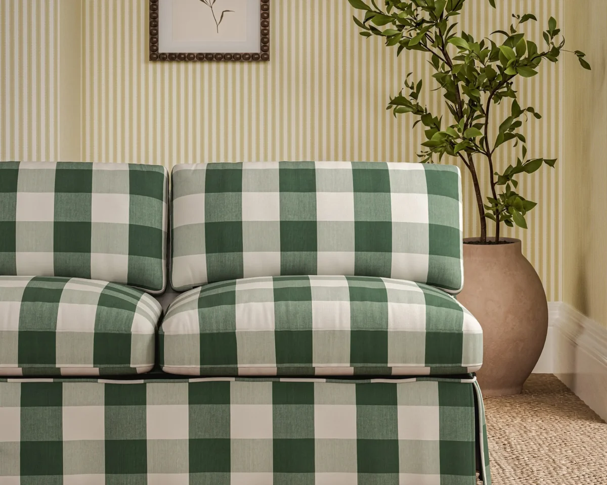 green checked sofa with plants and wall