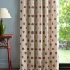 red spotted curtain with side table and lamps