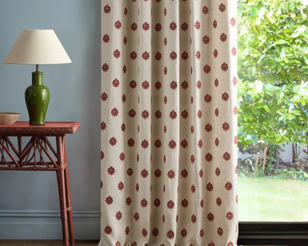 red spotted curtain with side table and lamps
