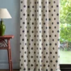blue spotted curtain with side table and lamps