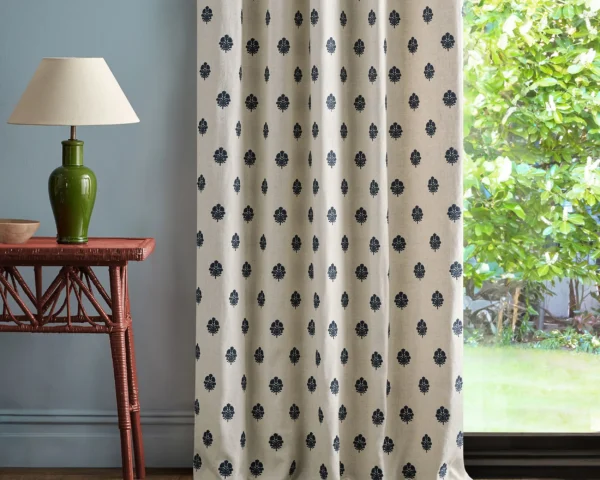 blue spotted curtain with side table and lamps