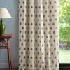 green spotted curtain with side table and lamps