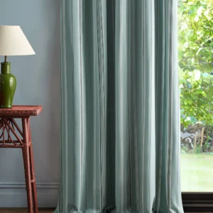 blue striped curtain with side table and lamps