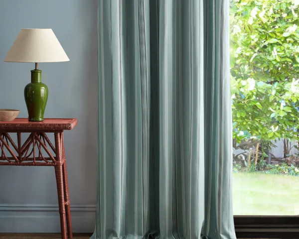 blue striped curtain with side table and lamps
