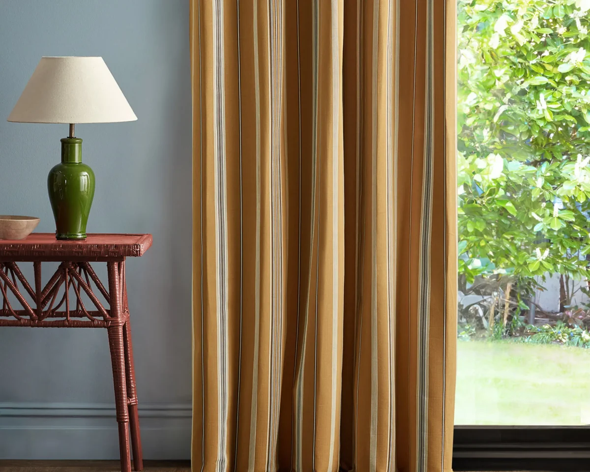 yellow striped curtain with side table and lamps