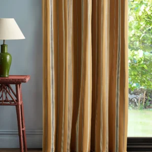 yellow striped curtain with side table and lamps