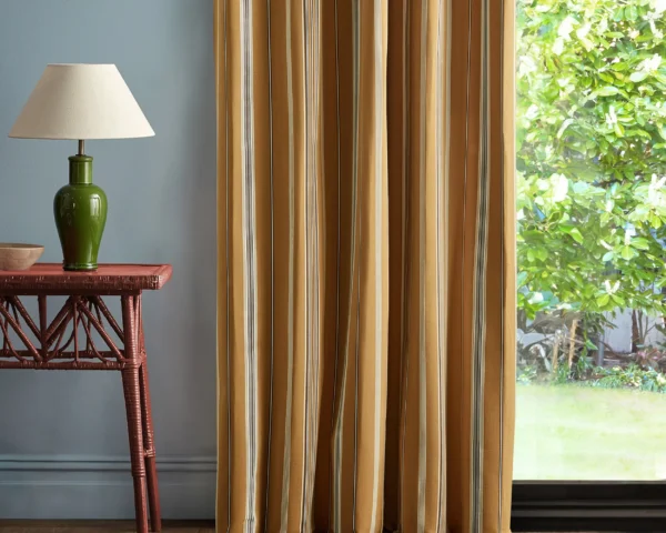Latimer Stripe Fabric - Turmeric / Walnut by yellow striped curtain with side table and lamps