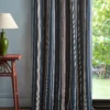 blue striped curtain with side table and lamps