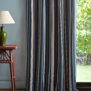 blue striped curtain with side table and lamps