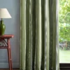 green striped curtain with side table and lamps