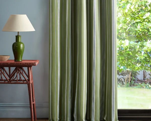 Latimer Stripe Fabric - Avocado / Indigo by green striped curtain with side table and lamps