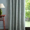 blue striped curtain with side table and lamps