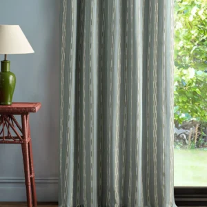 blue striped curtain with side table and lamps