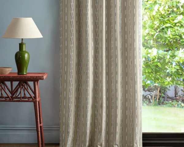 neutral striped curtain with side table and lamps