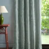 blue geometric curtain with side table and lamps