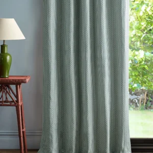 blue geometric curtain with side table and lamps