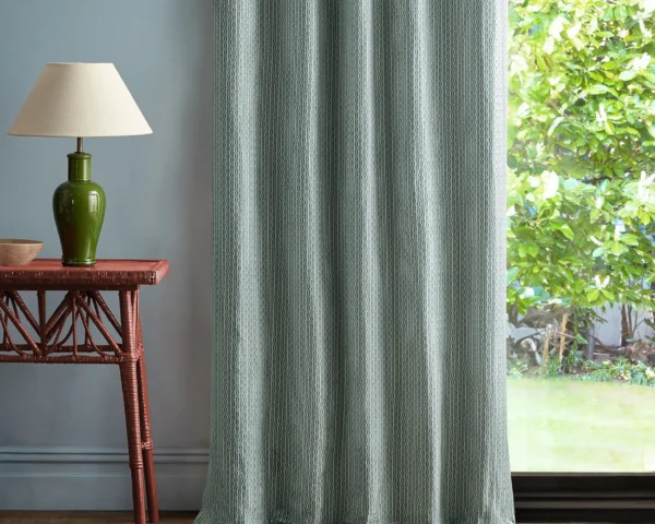 blue geometric curtain with side table and lamps