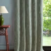 green geometric curtain with side table and lamps