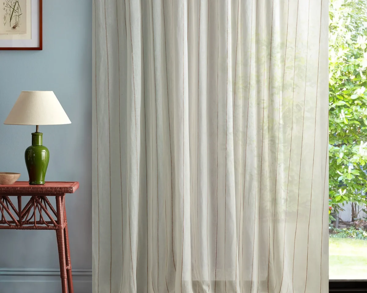 multicolour striped curtain with side table and lamps