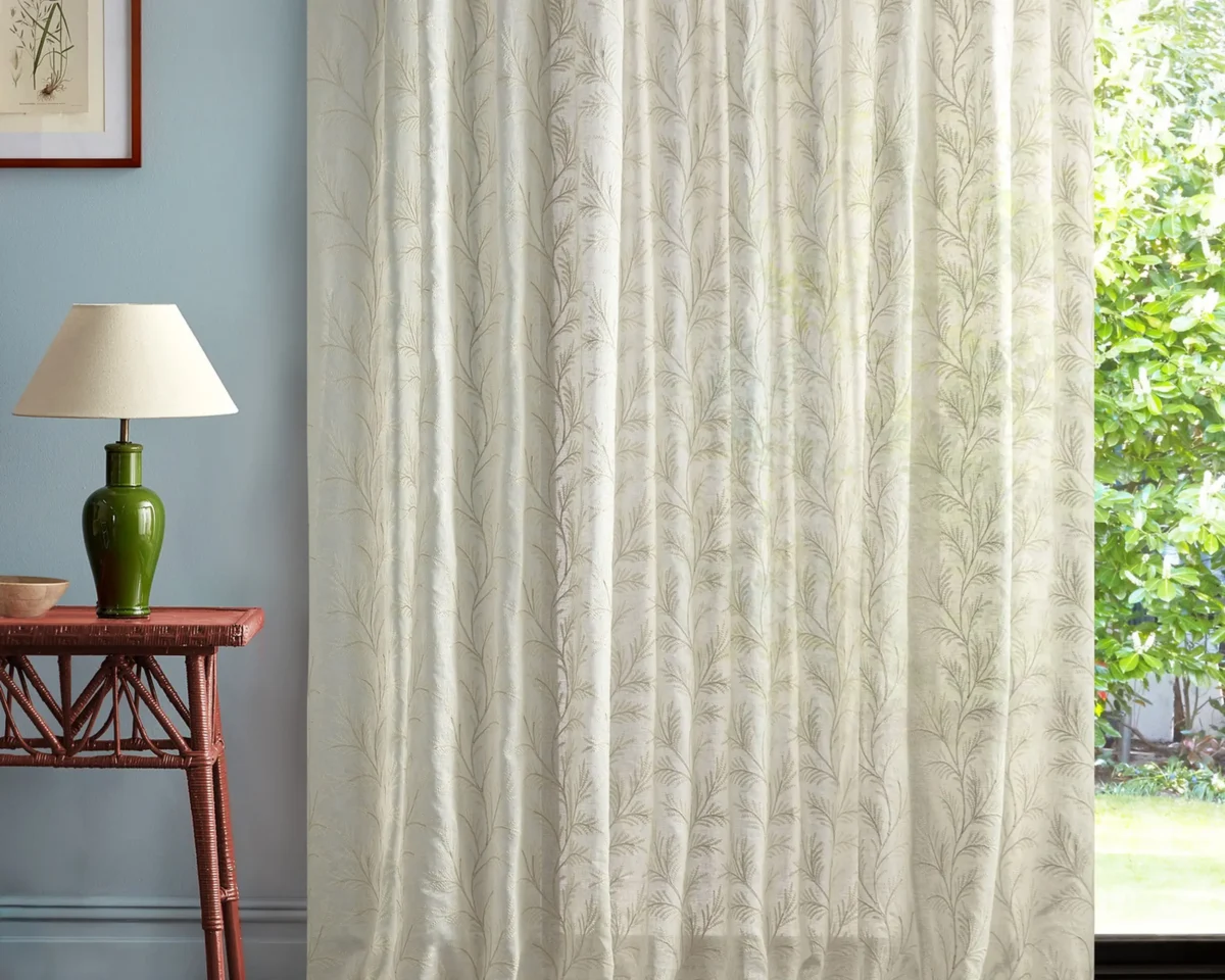 neutral botanical curtain with side table and lamps
