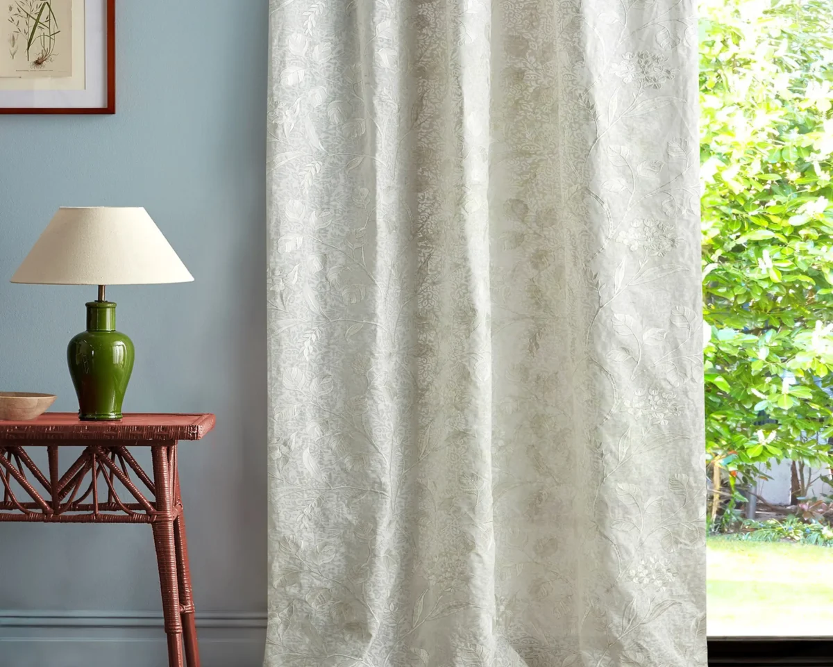 neutral botanical curtain with side table and lamps