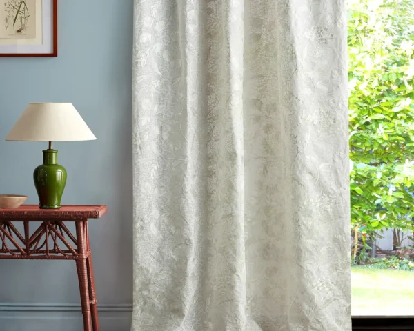 neutral botanical curtain with side table and lamps