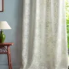 green botanical curtain with side table and lamps
